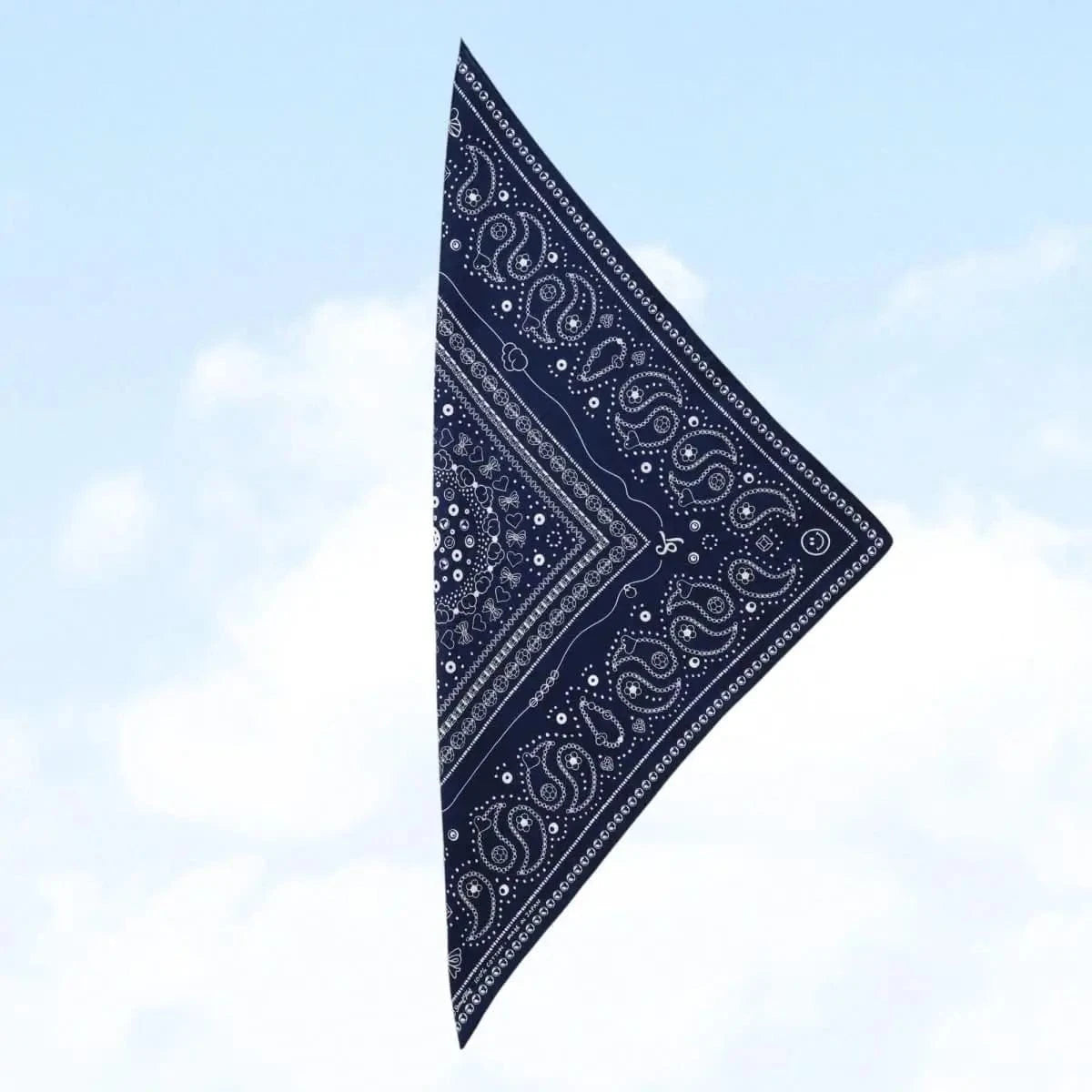 Close-up view of the indigo Bead Parade bandana, highlighting the detailed hand-drawn bead motifs and paisley elements.