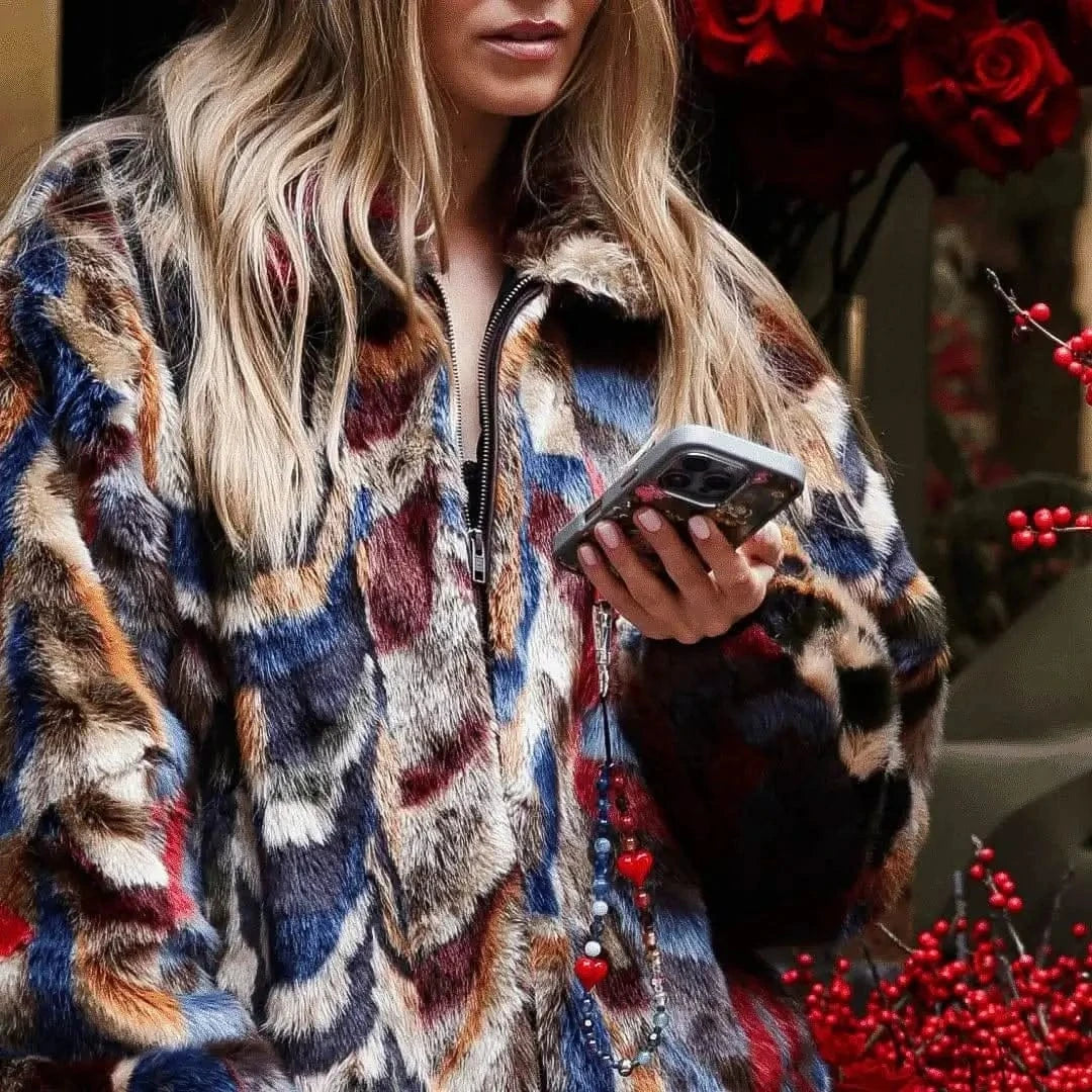 Person texting on a smartphone with the Chakra Shimmer Wristlet Phone Strap hanging from the device, featuring colorful beads and gemstones, highlighting the accessory's blend of style and functionality.