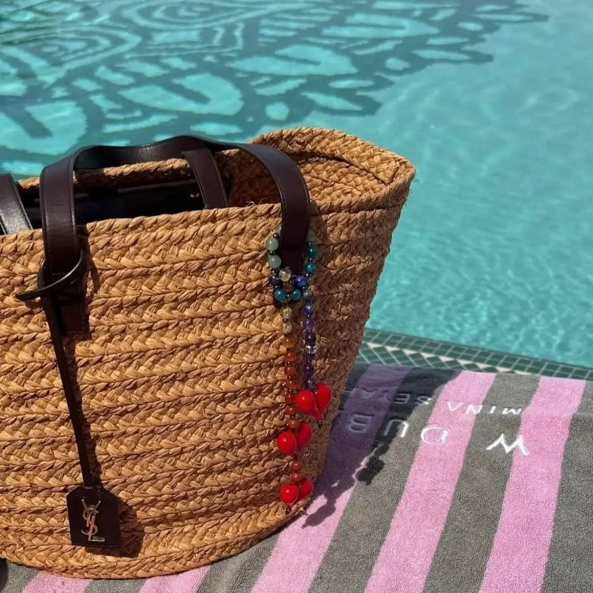 The Big Chakra Energy Bag Charm attached to a designer handbag, illustrating how the vibrant colors and elegant design add a personalized touch to everyday accessories