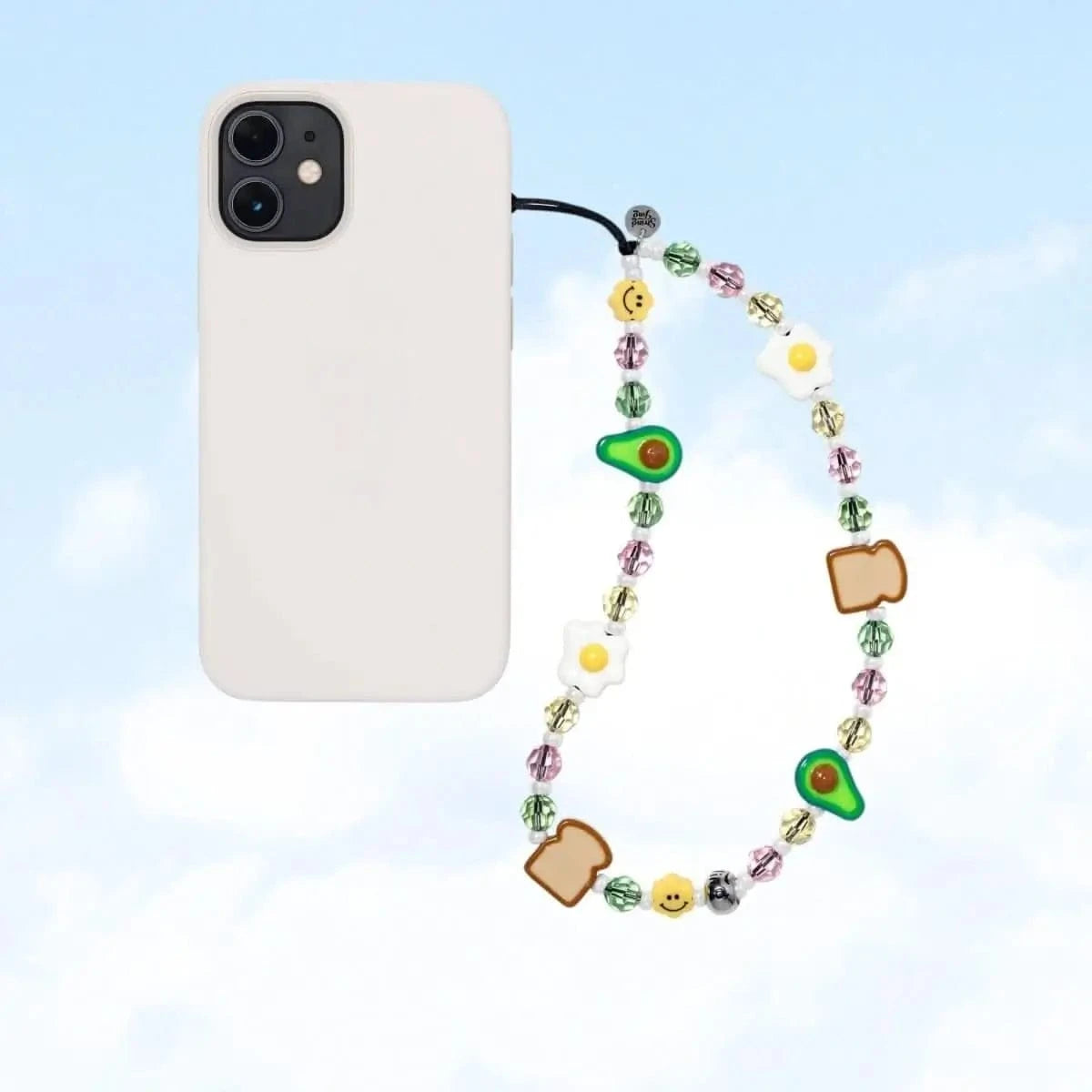 The Breakfast Club Drip Wristlet Phone Strap highlighting detailed beads of avocado, toast, and eggs alongside shimmering Swarovski® crystals.