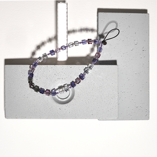 Multicolored beaded lanyard on a concrete surface